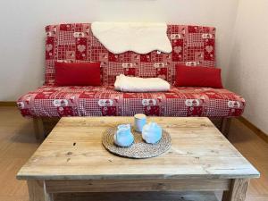 a living room with a couch and a coffee table at Résidence Parc Des Airelles - Studio pour 4 Personnes 734 in Le Mélézet