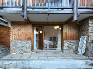 a front door of a house with a balcony at Résidence Parc Des Airelles - Studio pour 4 Personnes 734 in Le Mélézet