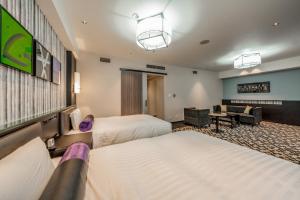 Tempat tidur dalam kamar di New Otani Inn Sapporo +37 foto
