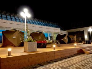 Miyako Hotel Gifu Nagaragawa في غيفو: مجموعة من الخيام أمام مبنى في الليل