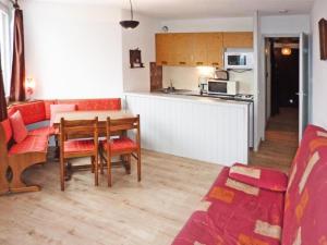 un soggiorno con tavolo e cucina di Résidence La Chamoisiere - Studio pour 4 Personnes 404 a Les Orres