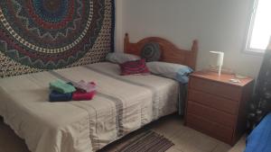 a bedroom with a bed with two pillows on it at laurainu in Puerto del Rosario