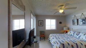 a bedroom with a bed and a flat screen tv at Beachmaster Unit 107 in Cherry Grove is an Oceanfront Condo in Myrtle Beach