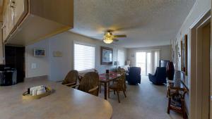 a dining room and living room with a table and chairs at Beachmaster Unit 107 in Cherry Grove is an Oceanfront Condo in Myrtle Beach