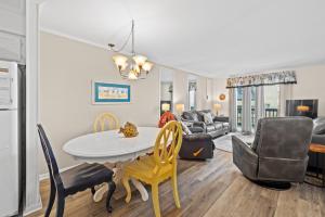 a kitchen and living room with a table and chairs at Sea Cabin Unit 125 Cherry Grove in Myrtle Beach