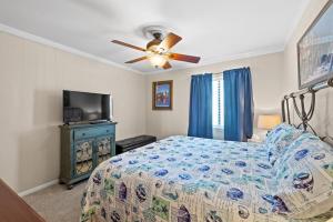 a bedroom with a bed and a ceiling fan at Sea Cabin Unit 125 Cherry Grove in Myrtle Beach