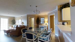a kitchen and living room with a glass table and chairs at Ocean Pointe Unit A2 in Myrtle Beach