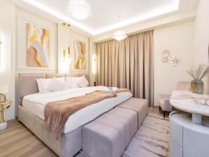 a bedroom with a large bed and a desk at FAM Living - Stunning 2 Bedroom Home In JBR in Dubai