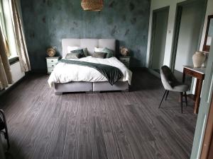 a bedroom with a bed and a desk and a chair at landlust.2 in Purmerend