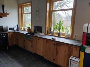 a kitchen with a large wooden counter with a window at landlust.2 in Purmerend