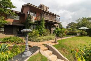 a house with a garden in front of it at Grape County Eco Resort & Spa, Nashik in Nashik