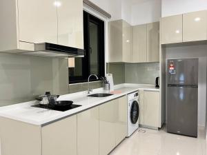 a white kitchen with a sink and a dishwasher at Paradigm Residence Johor Bahru in Johor Bahru