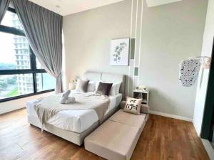 a bedroom with a white bed and a large window at Paradigm Residence Johor Bahru in Johor Bahru