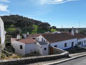 a group of white buildings with red roofs at Casa Tia Xica in Monsaraz