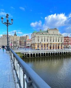 a bridge over a body of water with buildings at Bilder Boutique Hotel in Bilbao
