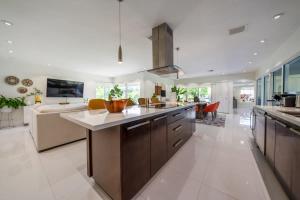 a large kitchen with a large island in a living room at Boho House - Stylist Home with Parking and large Yard in Miami