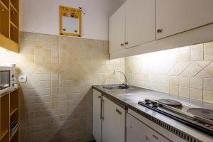 a kitchen with a sink and a counter top at LAUZES G - Appartement LAUZES 38 pour 5 Personnes 00 in Valmorel