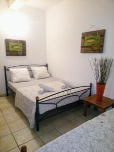 a bedroom with a bed with towels on it at Derveni Seaside Apartments "Groundfloor" in Derveni