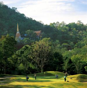 a group of people walking around a park with trees at Forget Me Not Boutique Bed & Breakfast Hua Hin in Hua Hin