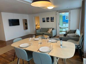 Pokój ze stołem i krzesłami oraz salonem w obiekcie Det grønne hus med isbjergsudsigt w mieście Ilulissat