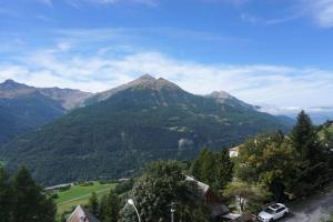 a view of a mountain with a car parked on a hill at Résidence Piniers - studio cabine 4 personnes MAE-2828 in Orcières +6 photos