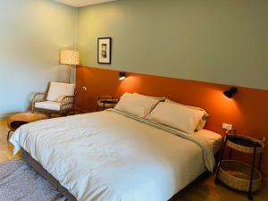 a bedroom with a large bed with an orange headboard at Forget Me Not Boutique Bed & Breakfast Hua Hin in Hua Hin +40 photos