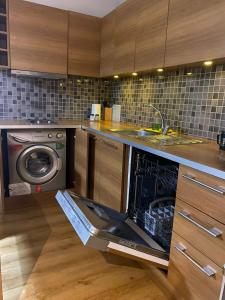 a kitchen with a dishwasher and a sink and a washing machine at D&D SUİTES in Istanbul