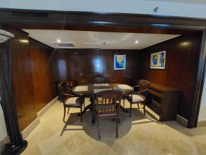 a dining room with a table and chairs at Pearl Continental Hotel, Rawalpindi in Rawalpindi