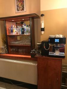a bar in a hotel room with a counter at Hotel Zeil in Frankfurt
