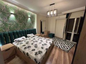 a bedroom with a bed and a green wall at Luxurious apartment in cairo in Cairo