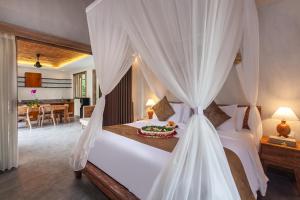 Postel nebo postele na pokoji v ubytování Uma Githa Ubud by Pramana Villas