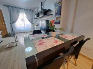 a dining room table with flowers on top of it at Nice 3 bedroom Duplex Cabo Roig in Orihuela Costa
