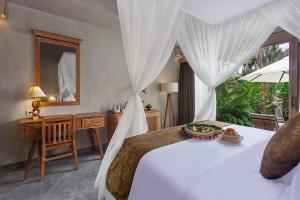 Postel nebo postele na pokoji v ubytování Uma Githa Ubud by Pramana Villas