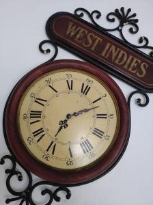 a clock hanging on a wall with anext indias sign at La Loupière in Avallon