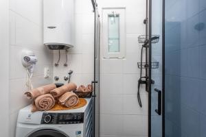 a washer and dryer in a bathroom with a shower at Apartment "CAROVO 7" in Kraljevica +61 photos