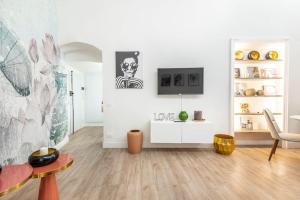 a living room with white walls and wooden floors at Wine_Home_Florence in Florence