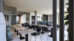 a restaurant with tables and chairs in a room at Motel Schlafraum Weng contactless check-In in Weng im Innkreis