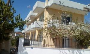 a large yellow building with a balcony at Panorama Hill in Grammatiko