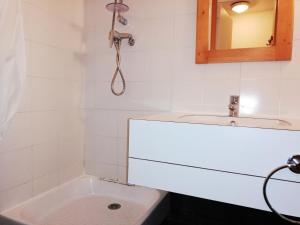 a bathroom with a sink and a toilet and a mirror at PORTAIL G - Appartement PORTAIL 40 pour 2 Personnes 17 in Valmorel