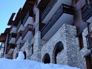 a building with a pile of snow in front of it at PORTAIL G - Appartement PORTAIL 40 pour 2 Personnes 17 in Valmorel