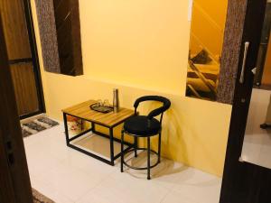 a black chair sitting next to a small table at The Madaar House in Varanasi