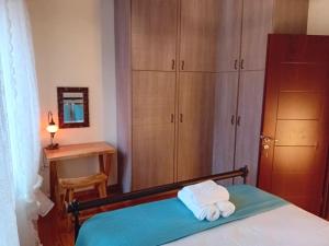 a bedroom with a bed with two towels on it at Ignatia's house in Polichnítos