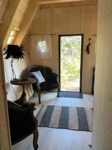 a room with a couch and a table and a window at Fairytale tinyhouse near the sea - Häxans hus in Gothem