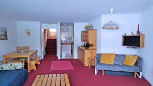 a living room with a couch and a table at Résidence Cortina 2 - Appartements pour 6 Personnes 884 in Les Prés