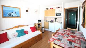 una camera con divano e tavolo in cucina di Résidence Parc Aux Etoiles - C212PAE - APPARTEMENT 2 CHAMBRES AVEC BALCON MAE-9024 a Narreyroux