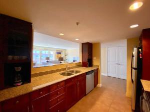 a large kitchen with a sink and a refrigerator at Spacious Waterfront Apt #801 with AC in Halifax