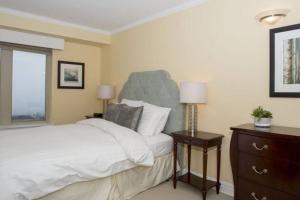 a bedroom with a large bed with a blue headboard at Spacious Waterfront Apt #801 with AC in Halifax