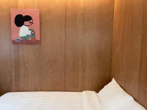 Giường trong phòng chung tại Chuncheon Diary Stay