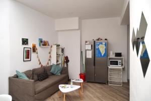 a living room with a couch and a refrigerator at Room with Private Bathroom - Vivienda Vacacional Out of Blue in Santa Cruz de la Palma