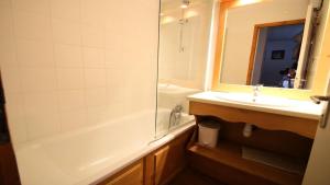 a bathroom with a tub and a sink and a shower at Résidence Dame Blanche - 2 Pièces pour 6 Personnes 194 in Narreyroux